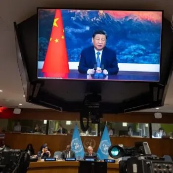 Xi Jinping (on screen), President of the People's Republic of China, addresses a meeting on Climate and Just Transition convened by Secretary-General António Guterres (seated between flags) and Luiz Inácio Lula da Silva (not pictured), President of Brazil.