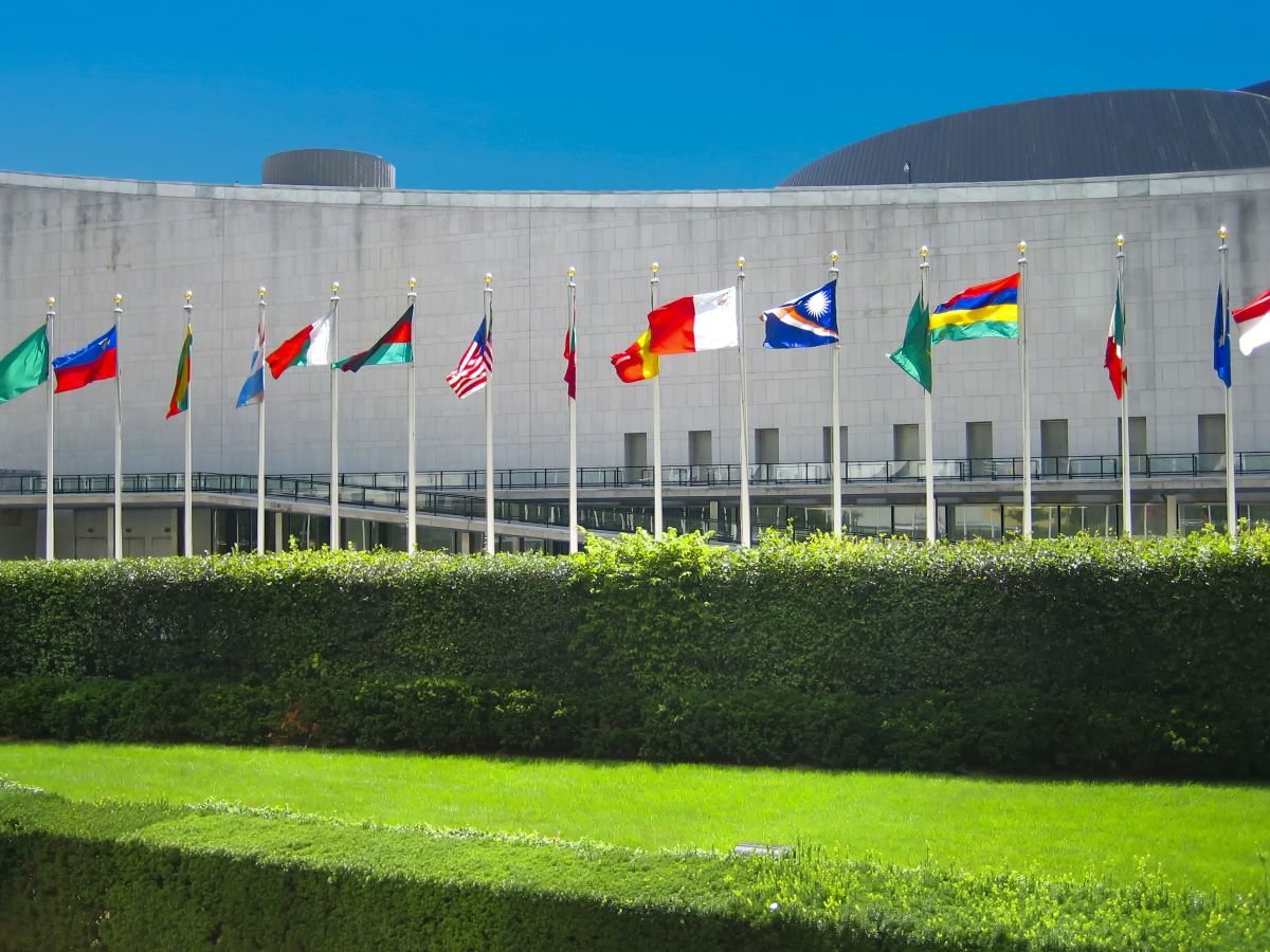 United Nations General Assembly hall with flags of their members in New York