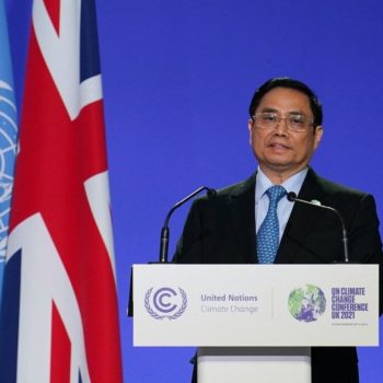 Vietnam's Prime Minister Pham Minh Chinh, who committed the country to no new coal at COP26, presents his national statement as part of the COP World Leaders' Summit in Glasgow. Behind him are UN and UK flags.