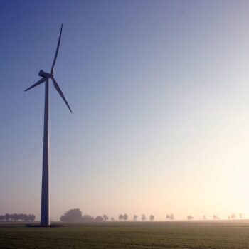 Wind turbine looknig towards the sunrise in Bergen, Germany. Photo by Jason on Flickr.