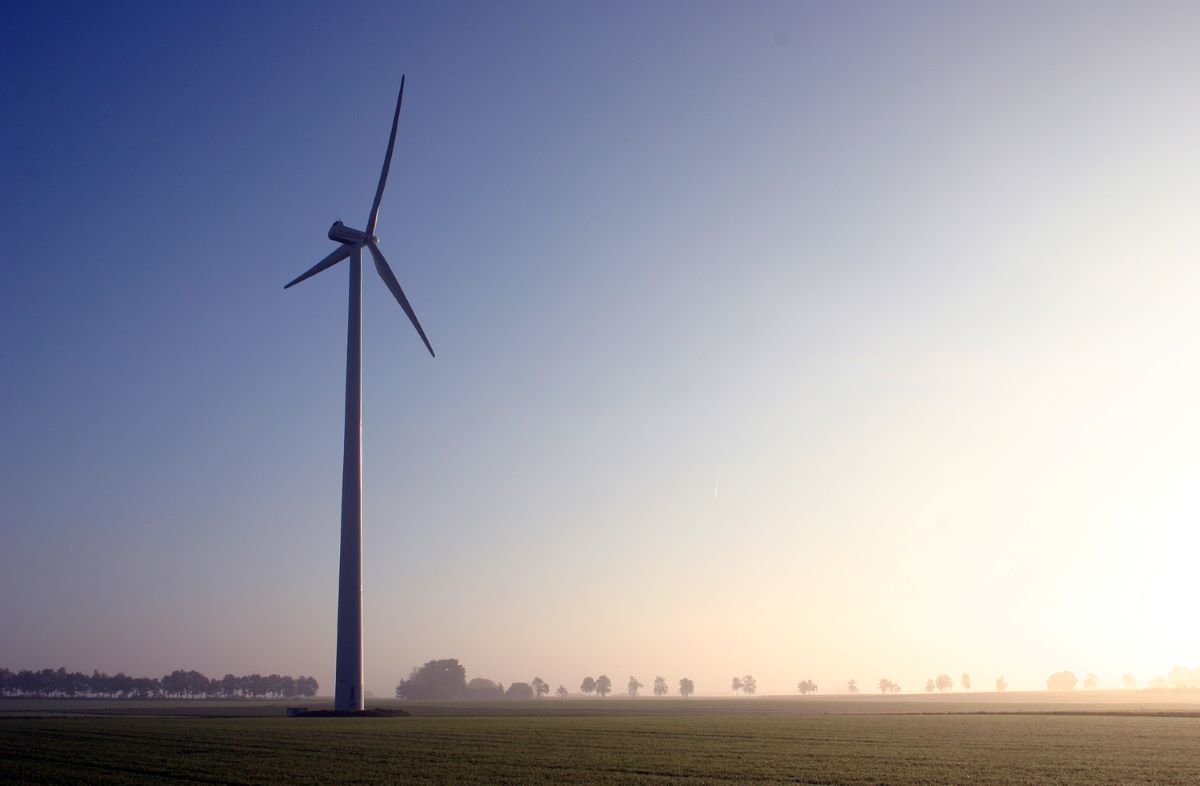 Wind turbine looknig towards the sunrise in Bergen, Germany. Photo by Jason on Flickr.