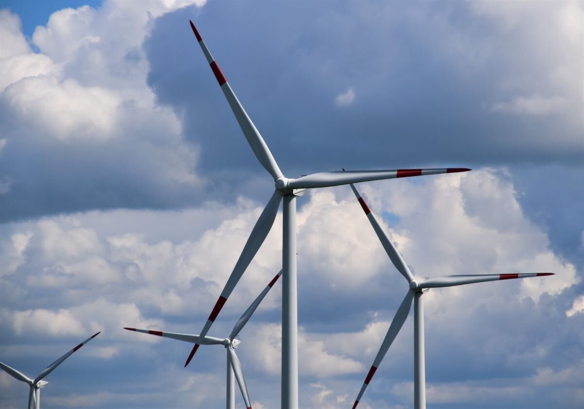 Wind turbines against a cloudy sky in Schleswig-Holstein, Deutschland.
