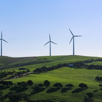 Wind turbines on green rolling hills
