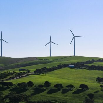 Wind turbines on green rolling hills