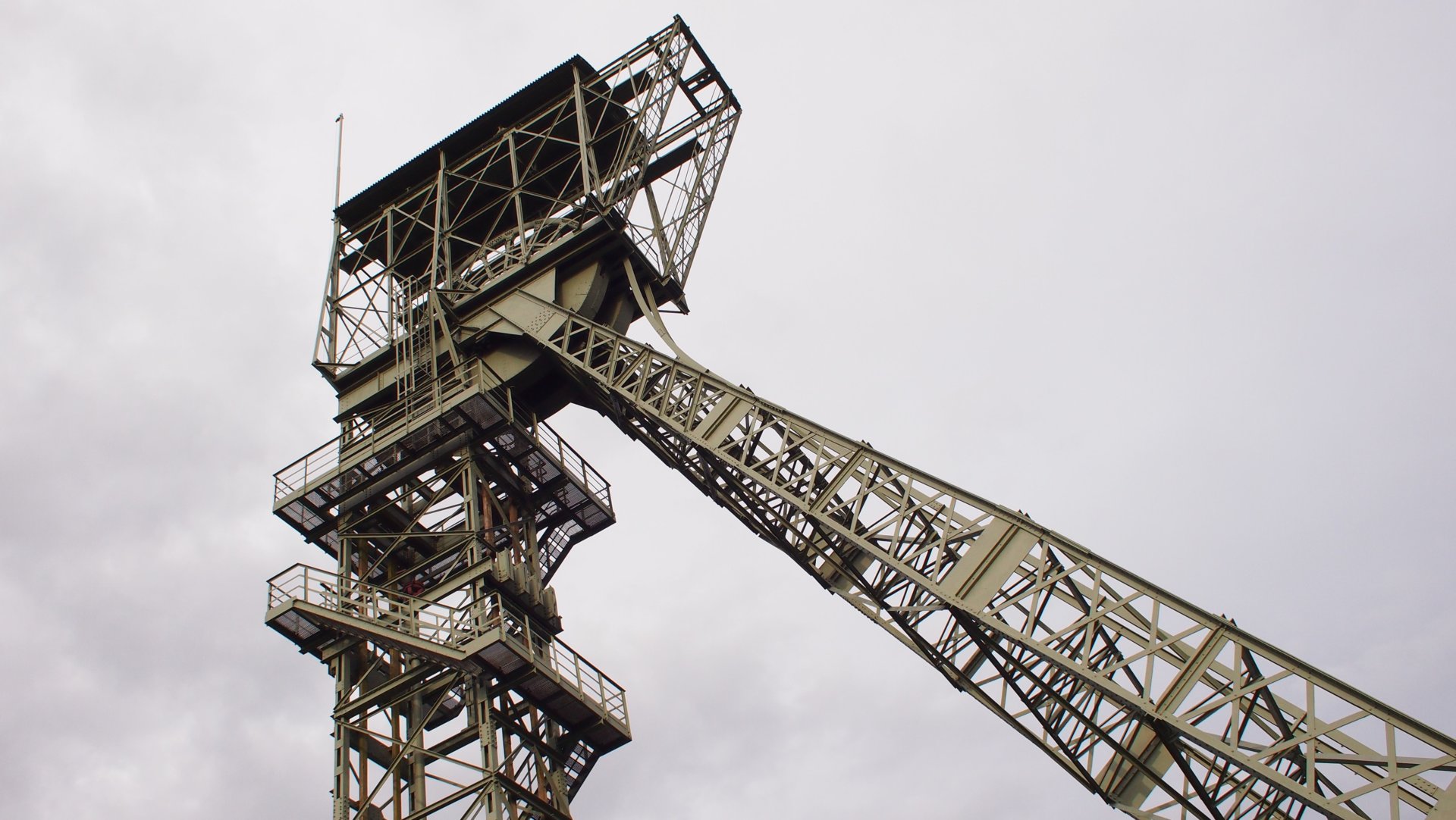 Hoisting tower of a coal mine against grey sky