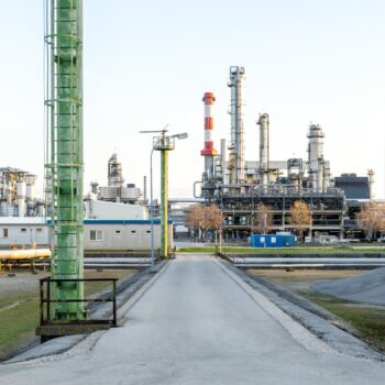 Oil refinery against pale blue sky