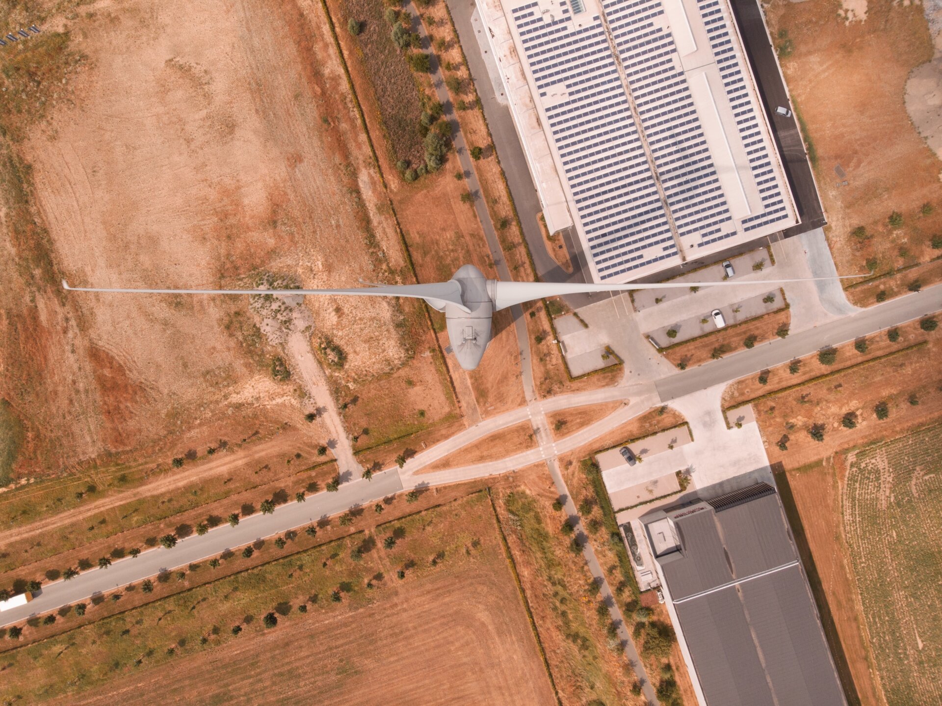 Top-down shot of wind turbine in desert.