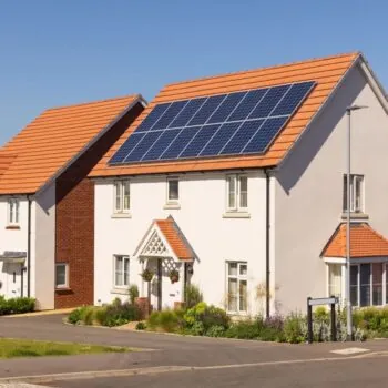 An image of a white house with solar panels in the UK.