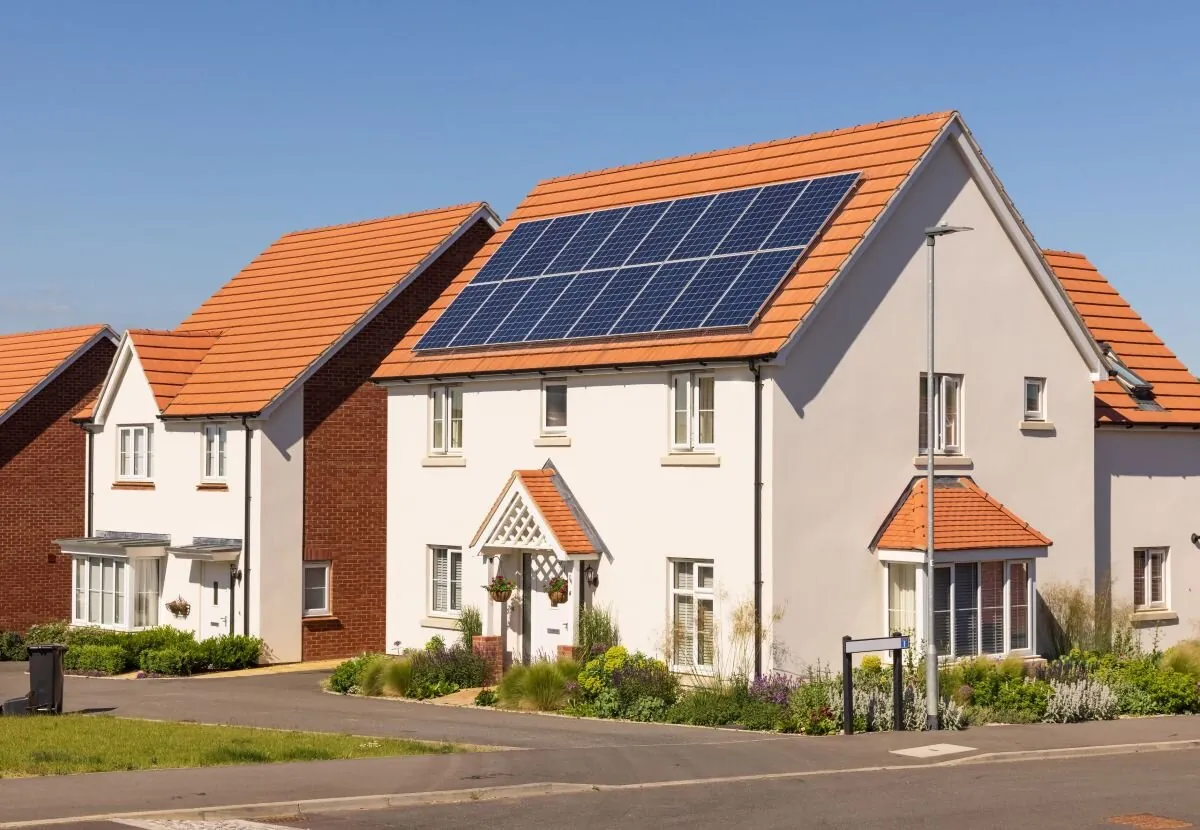 An image of a white house with solar panels in the UK.